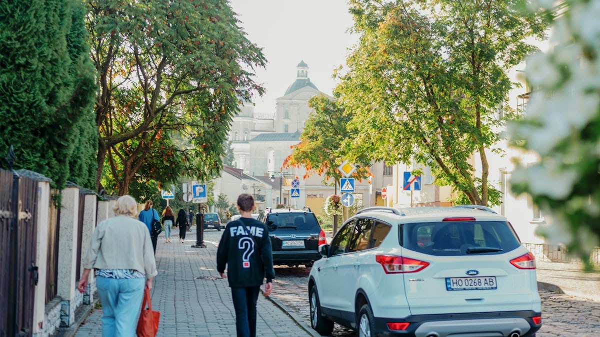 a couple of people walking down a sidewalk